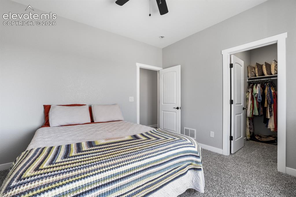 Image 30 of 50: Neutral gray walls with white trim, gray textured carpeting, and a ceiling