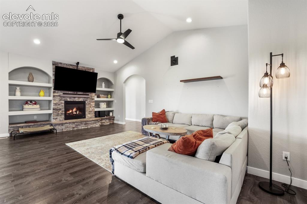 Image 4 of 50: Living area featuring vaulted ceilings, recessed lighting, and wood-finish