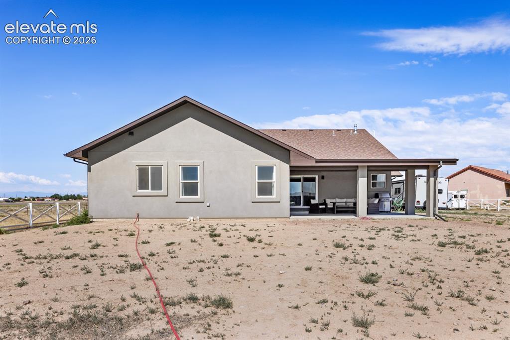 Image 48 of 50: Modern ranch-style home situated on expansive acreage with a covered front 