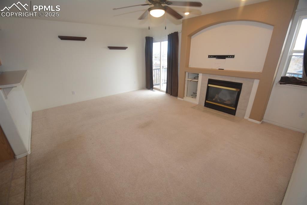 Image 11 of 48: Family room with gas fireplace and walk out to back deck
