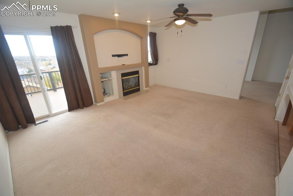 Image 12 of 48: Family room with gas fireplace and walk out to back deck