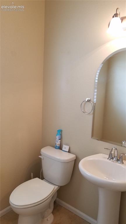 Image 10 of 32: Compact powder room featuring a white pedestal sink with chrome faucet, a w