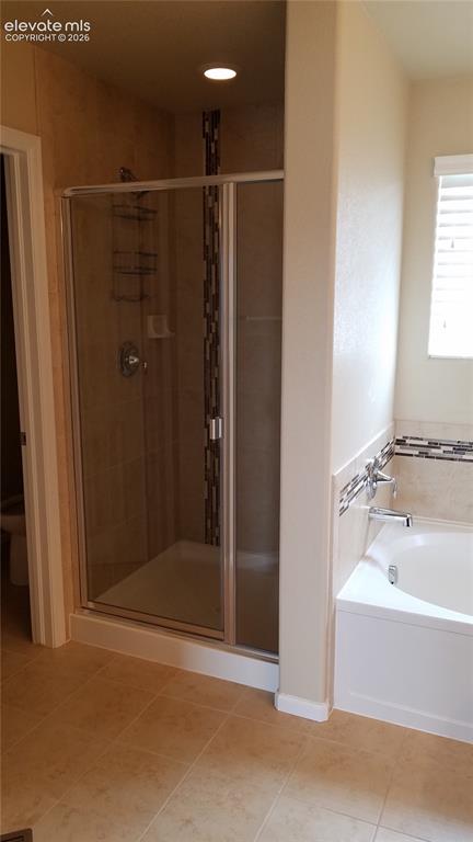 Image 17 of 32: Enclosed shower with tiled surround and decorative mosaic accent