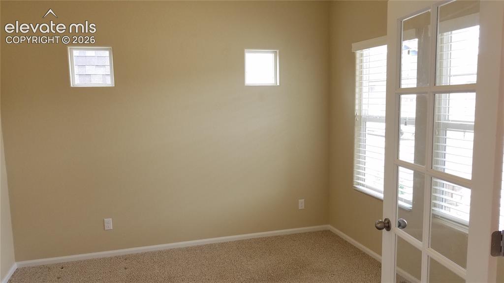 Image 2 of 32: Room featuring neutral wall paint, light-colored carpet, and white baseboar