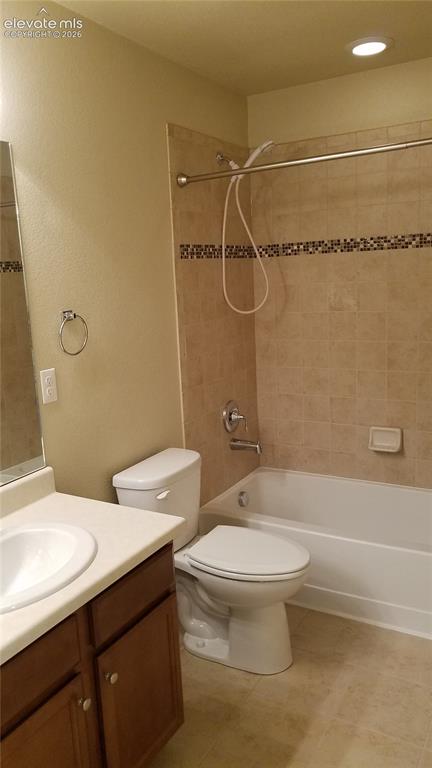 Image 21 of 32: Full bathroom featuring a white tub, light-toned ceramic wall tile with a m