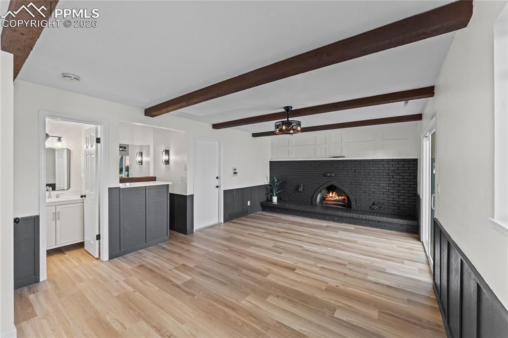 Image 17 of 47: Family room w/ wood burning fireplace