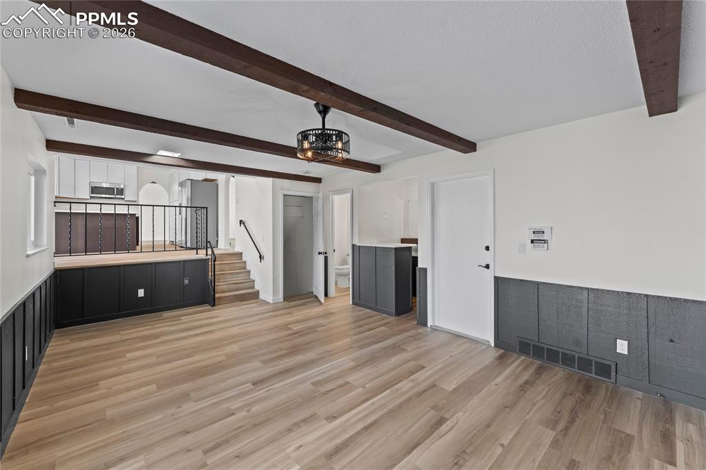 Image 18 of 47: Family room w/ wood burning fireplace