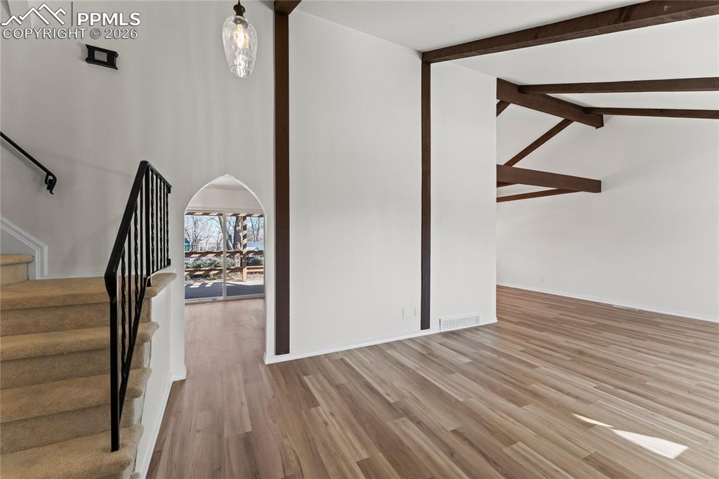 Image 5 of 47: Living room w/ vaulted ceilings & real wood beams