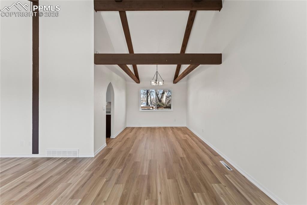 Image 8 of 47: Formal dining room w/wood beams & glass chandelier