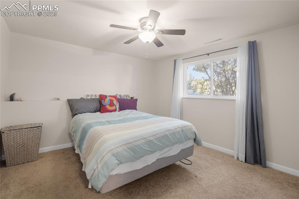 Image 8 of 15: Bedroom with light carpet and ceiling fan