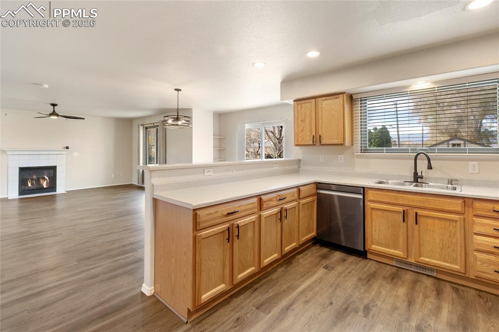 Image 11 of 37: Kitchen featuring light countertops, dark wood-type flooring, a peninsula, 