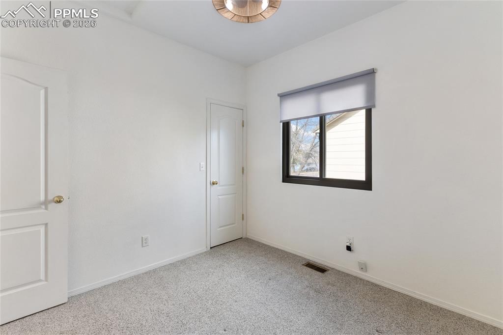 Image 22 of 37: Spare room with baseboards and carpet floors