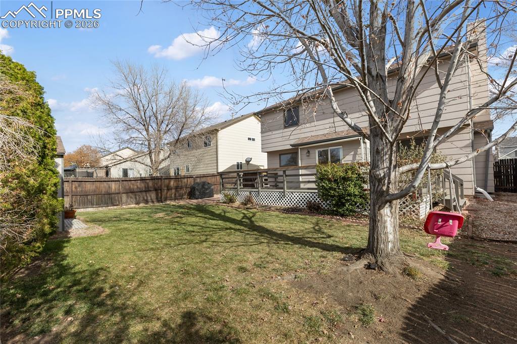 Image 34 of 37: Back of house featuring a wooden deck