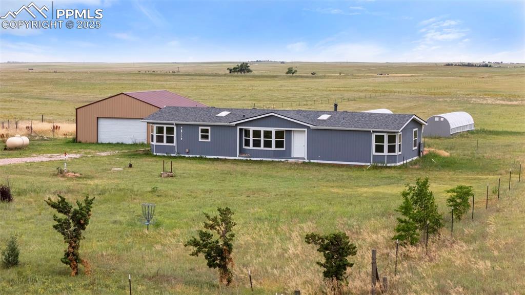 Image 3 of 34: Rear view of property with a view of countryside and a yard