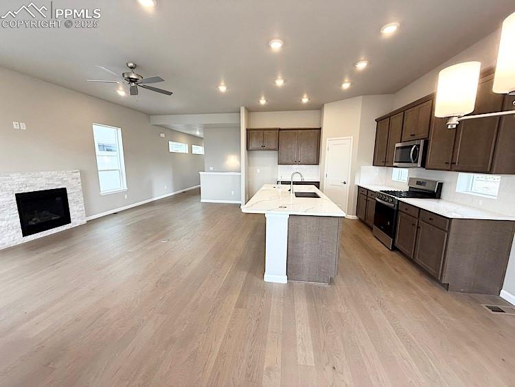Image 10 of 30: Kitchen with quartz countertops, pantry, large island providing additional 