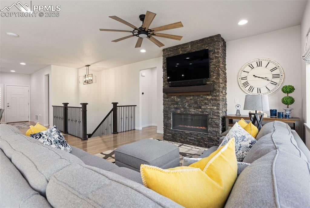 Image 10 of 41: View from living room to stairs leading to lower level