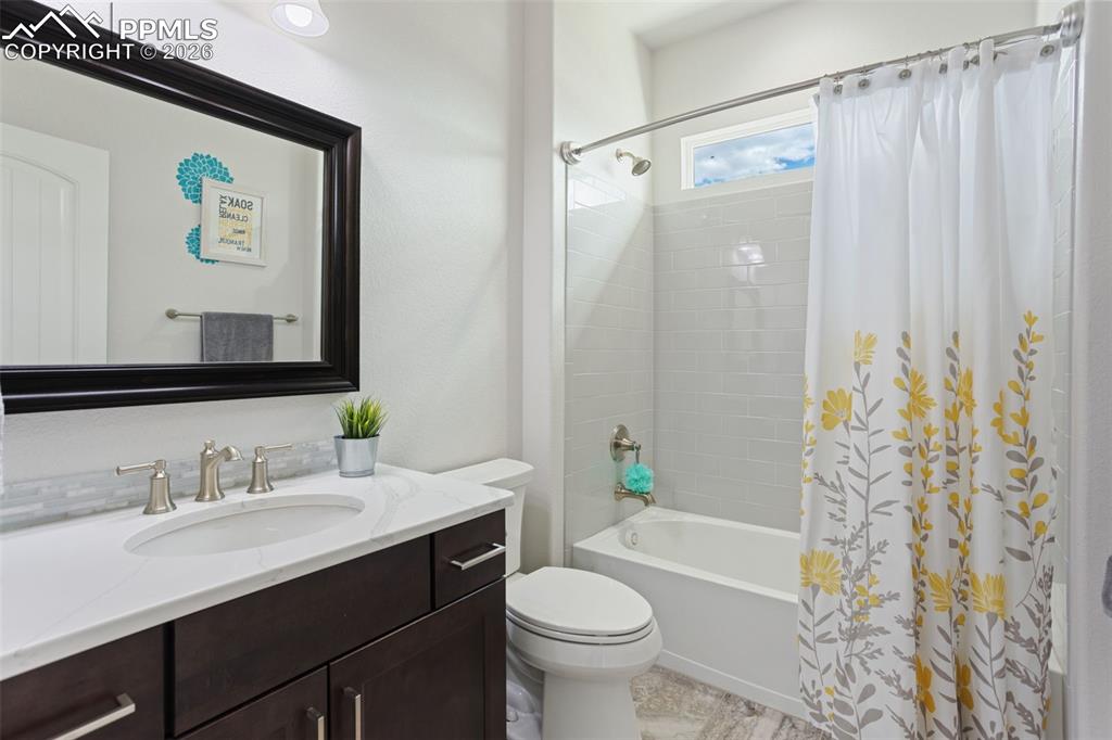 Image 18 of 41: Second full bath on main level adjacent to bedroom/office