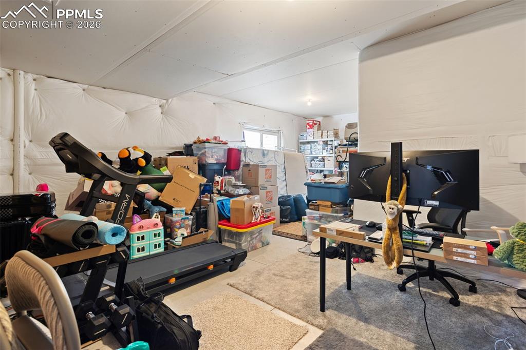 Image 29 of 41: Unfinished storage area pre-plumbed for bath; can be finished into a junior