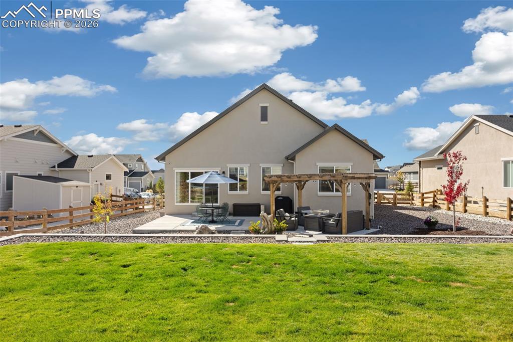Image 32 of 41: Back of house with spacious patio area, a fenced backyard, stucco siding, a