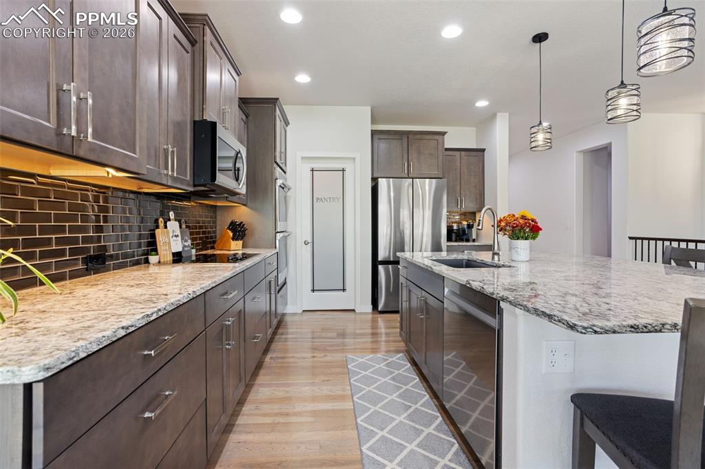 Image 6 of 41: View from dining area of kitchen and large walk-in pantry