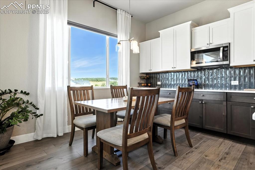 Image 10 of 50: Dining room with light wood finished floors