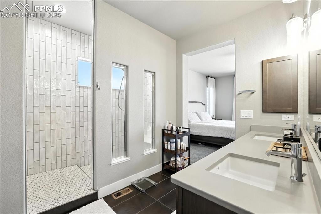 Image 20 of 50: Ensuite bathroom with double vanity and walk in shower