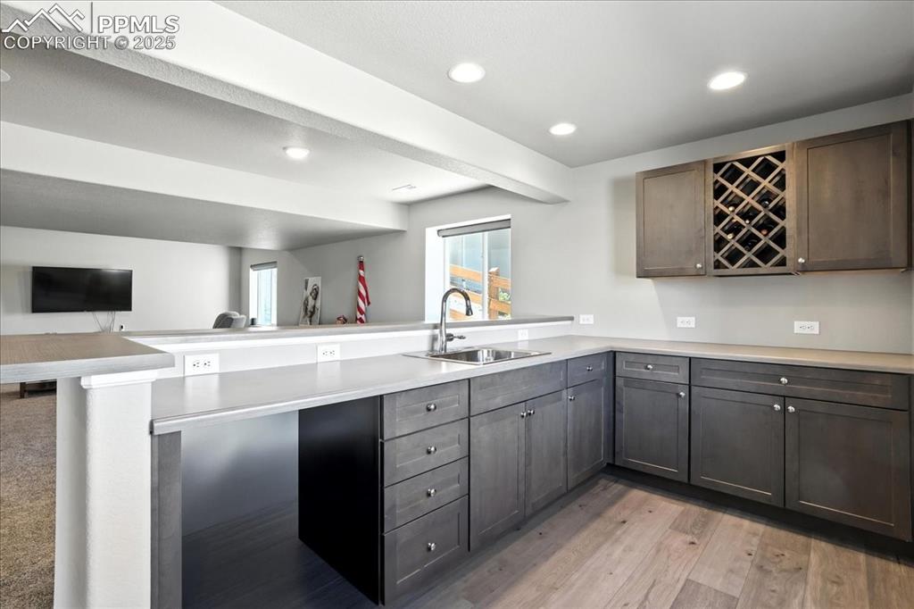 Image 24 of 50: Kitchen with a peninsula, recessed lighting, open floor plan, light counter