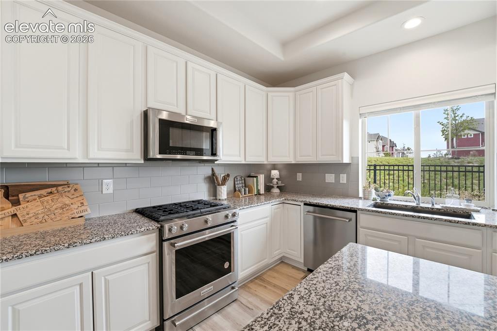 Image 12 of 50: Island seating in kitchen.