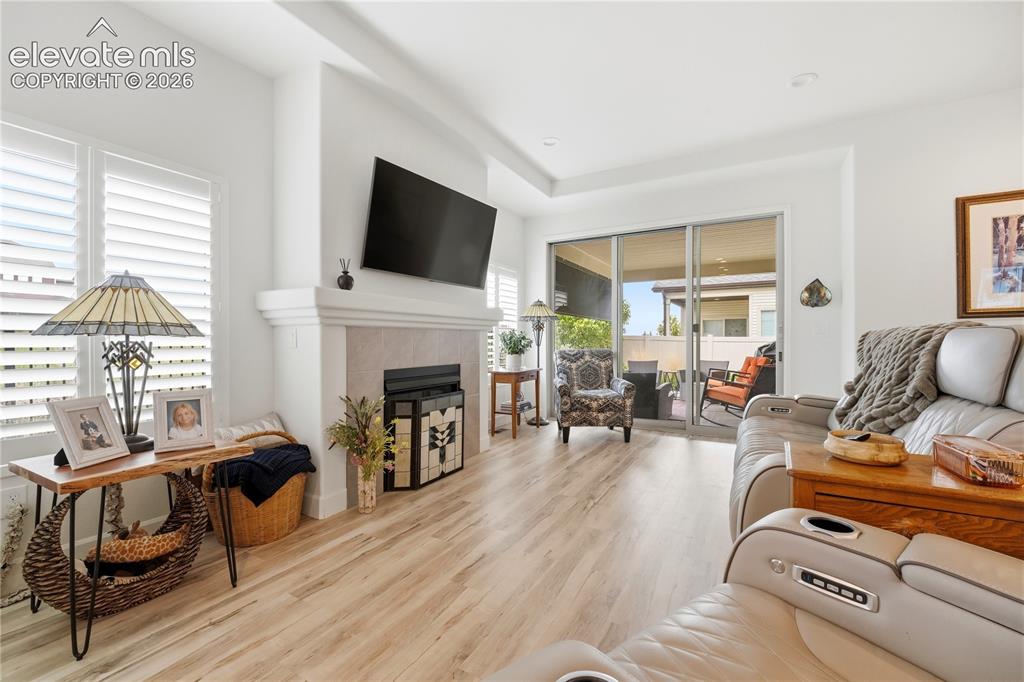 Image 15 of 50: Living area contemporary fireplace and plantation shutters