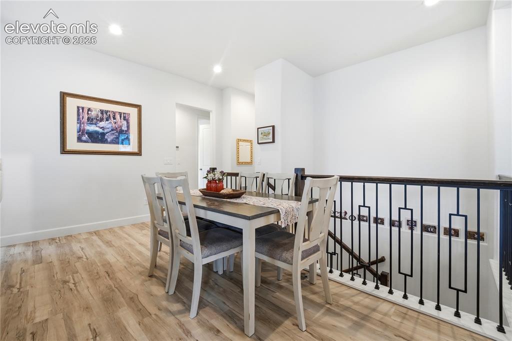 Image 19 of 50: Dining area with decorative black metal balusters