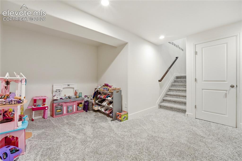 Image 30 of 50: Spacious basement office or recreation area. 