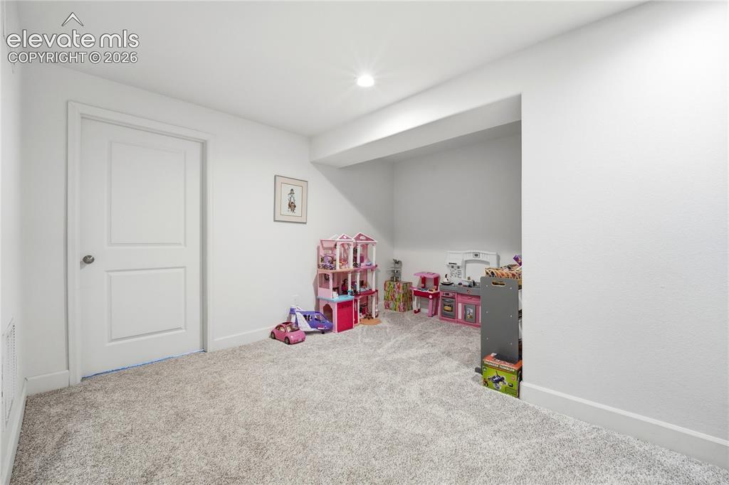 Image 31 of 50: Recessed alcove with light-toned carpet, a built-in ceiling light, painted 