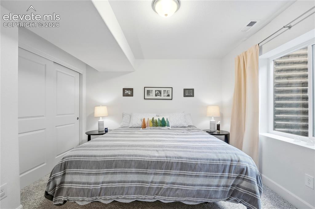 Image 36 of 50: Well-lit basement bedroom 