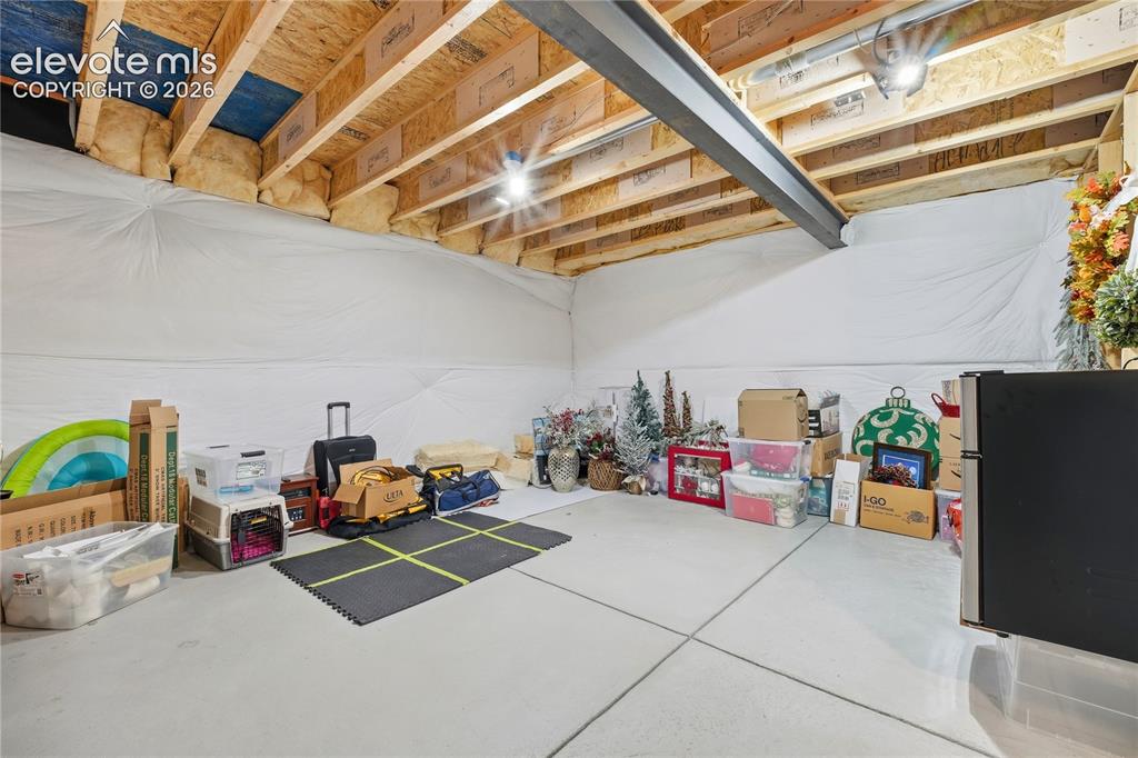 Image 38 of 50: Unfinished storage area in the basement