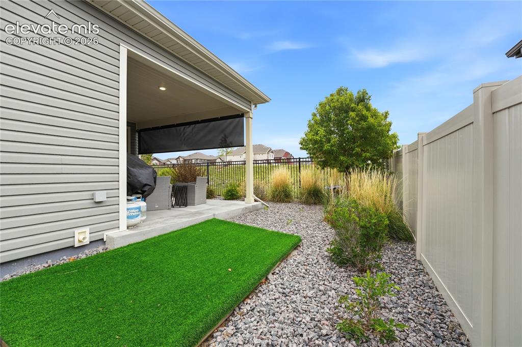 Image 6 of 50: Fully fenced yard with tall privacy fencing.