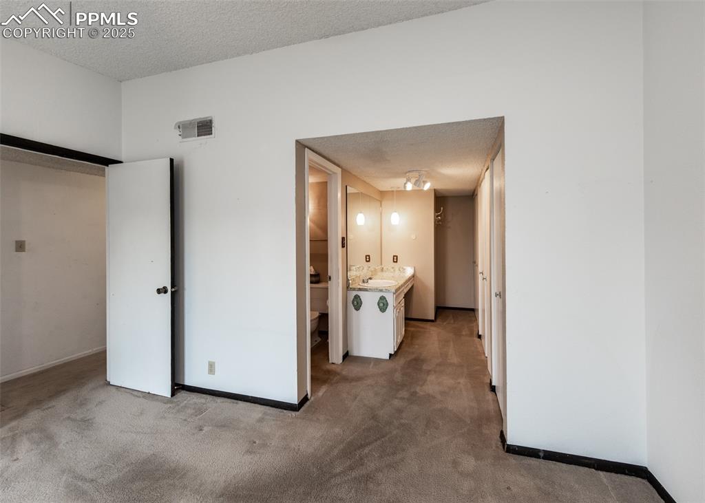 Image 21 of 40: Master Bedroom with adjoining bathroom