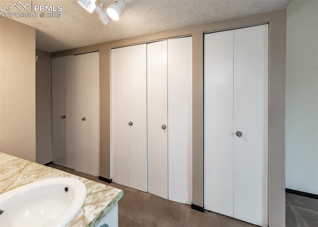 Image 25 of 40: Bathroom with vanity and a textured ceiling