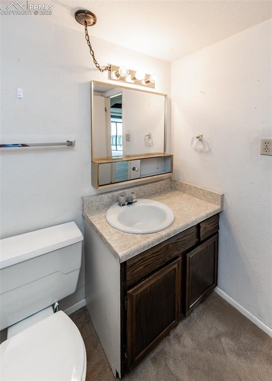 Image 35 of 40: Half bath with toilet and vanity