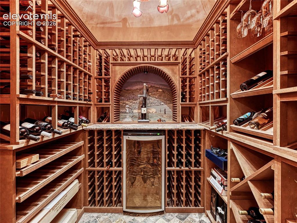 Image 20 of 50: Wine room with wine frig, custom light fixture and custom mural artwork by