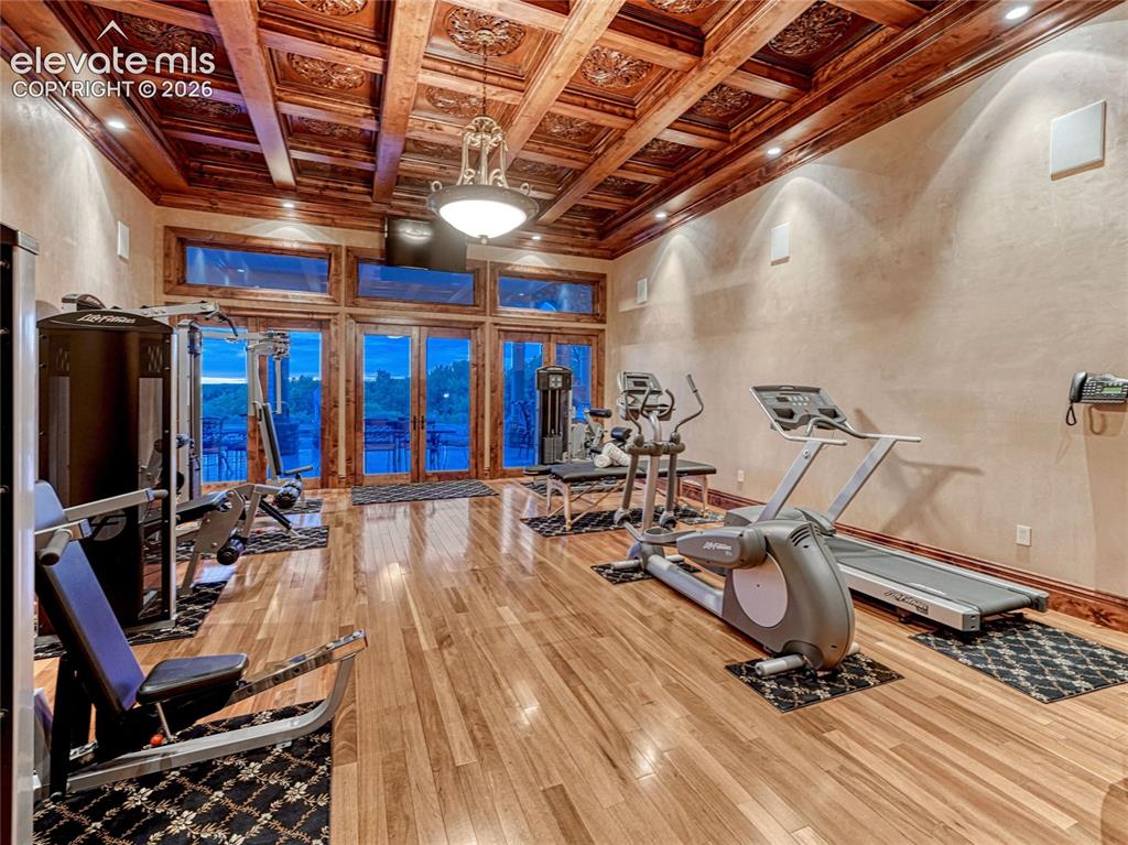 Image 33 of 50: Fitness space is one of two rooms with magnificent coffered ceiling.
