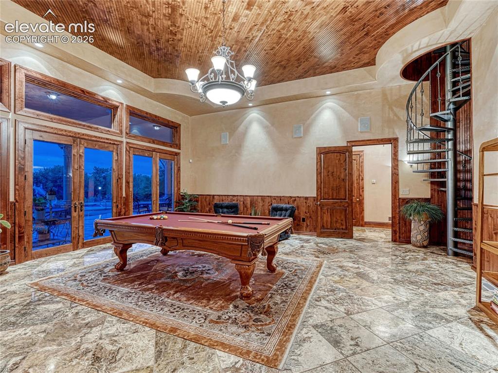 Image 35 of 50: Game room w/outdoor access and spiral staircase leading to observatory.