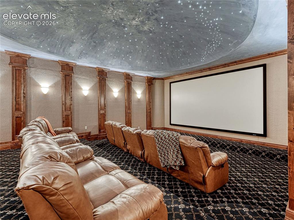 Image 37 of 50: Home media center w/wet bar, stadium seating and domed, fibre optic night-s
