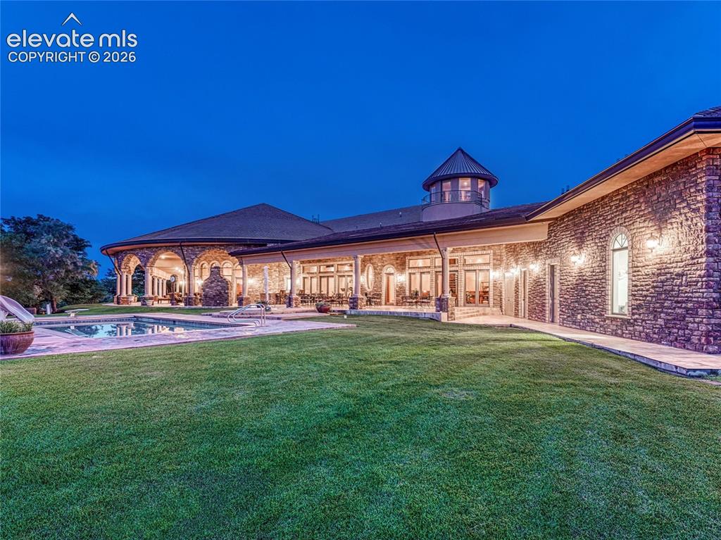 Image 50 of 50: Covered terrace, indoor/outdoor kitchen, gas fireplace, observatory up abov