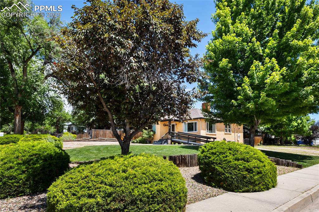 Image 2 of 34: Beautiful landscape and large corner lot.