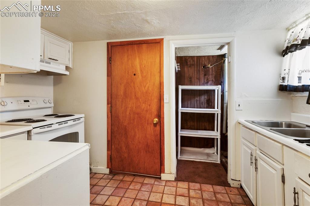 Image 25 of 34: Basement apartment kitchen and pantry