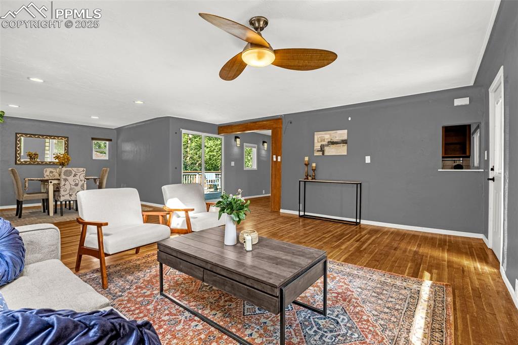 Image 10 of 42: Living room featuring wood finished floors, ceiling fan, and recessed light