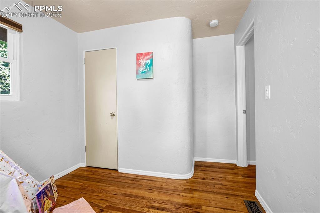 Image 21 of 42: Unfurnished bedroom featuring wood finished floors and baseboards