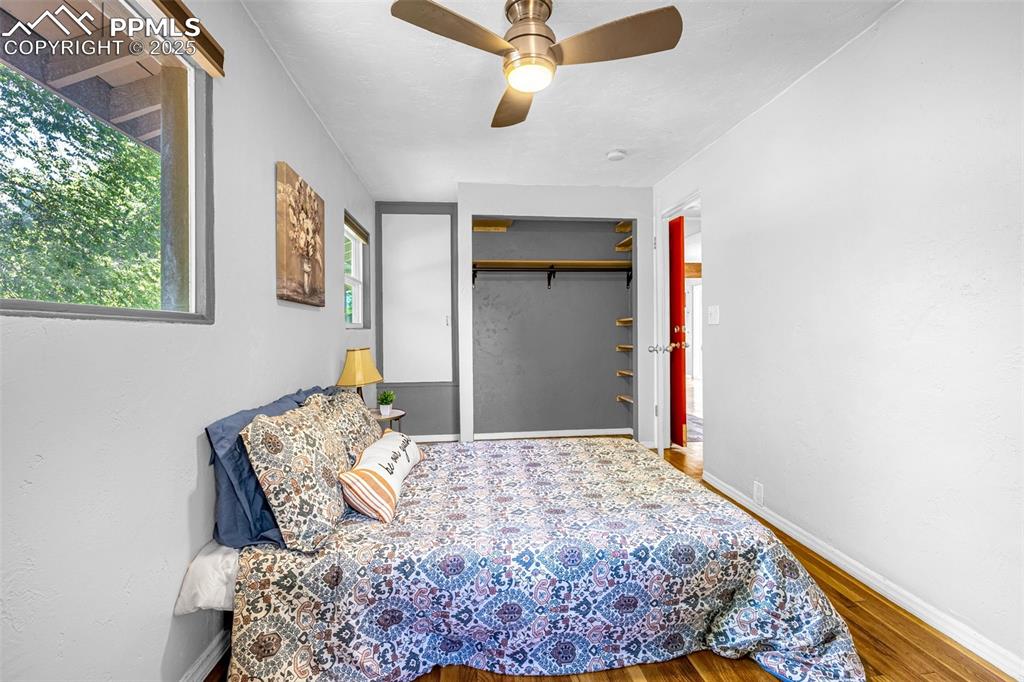 Image 23 of 42: Bedroom featuring wood finished floors, a ceiling fan, and a closet