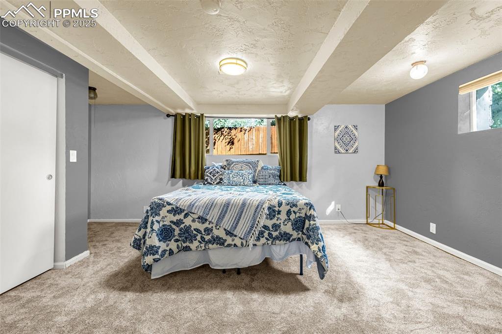 Image 30 of 42: Bedroom featuring carpet flooring and a textured ceiling