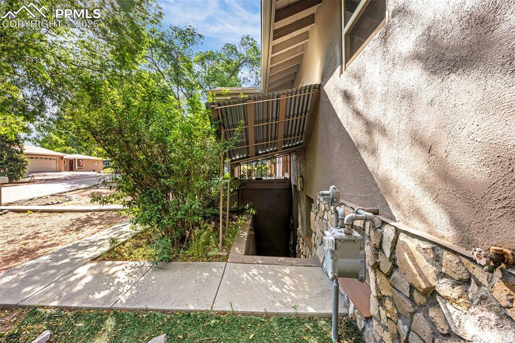 Image 34 of 42: View of exterior entry with stucco siding and stone siding